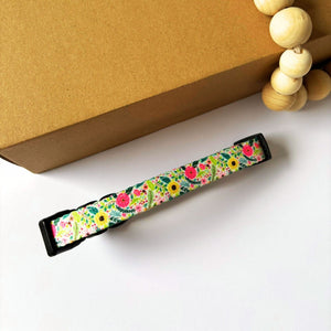 Top view of the back side of our Bloom Floral Dog Collar showing the adjustable strap slider for a custom fit. Features secure 4-point locking buckle and strong D-ring, suitable for dogs from XS to L.