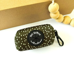 Dottie Days olive green dog poop bag holder flat lay with cream polka dots and black clip by Pet Store Collective.