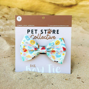 Straight on view of our Summer Bliss dog bow tie. Made from soft polyester fabric with a Velcro backing that attaches to any pet collar, designed for comfort and summer style. Limited release by Pet Store Collective.