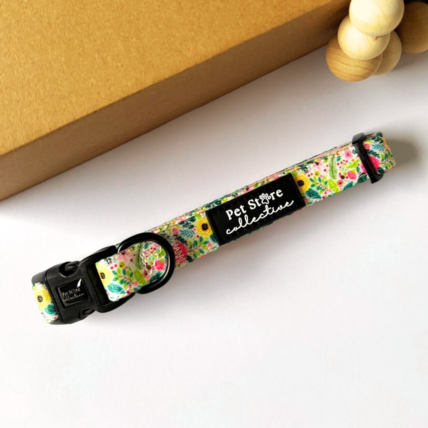 Close-up top view of the Bloom Floral Dog Collar showcasing our vibrant floral design in pink and green. Crafted  with custom polyester wedding, inner neoprene padding and a sturdy D-ring, available in sizes XS–L for dogs of all breeds.