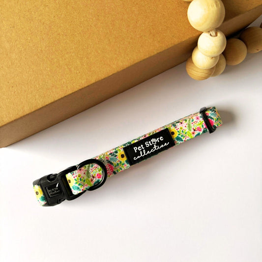 Top view of our Bloom Floral Dog Collar with blush pink roses and soft greenery print. Features adjustable fit, secure 4-point locking buckle, and strong D-ring for lead attachment. Available in XS–L for small to large breeds.