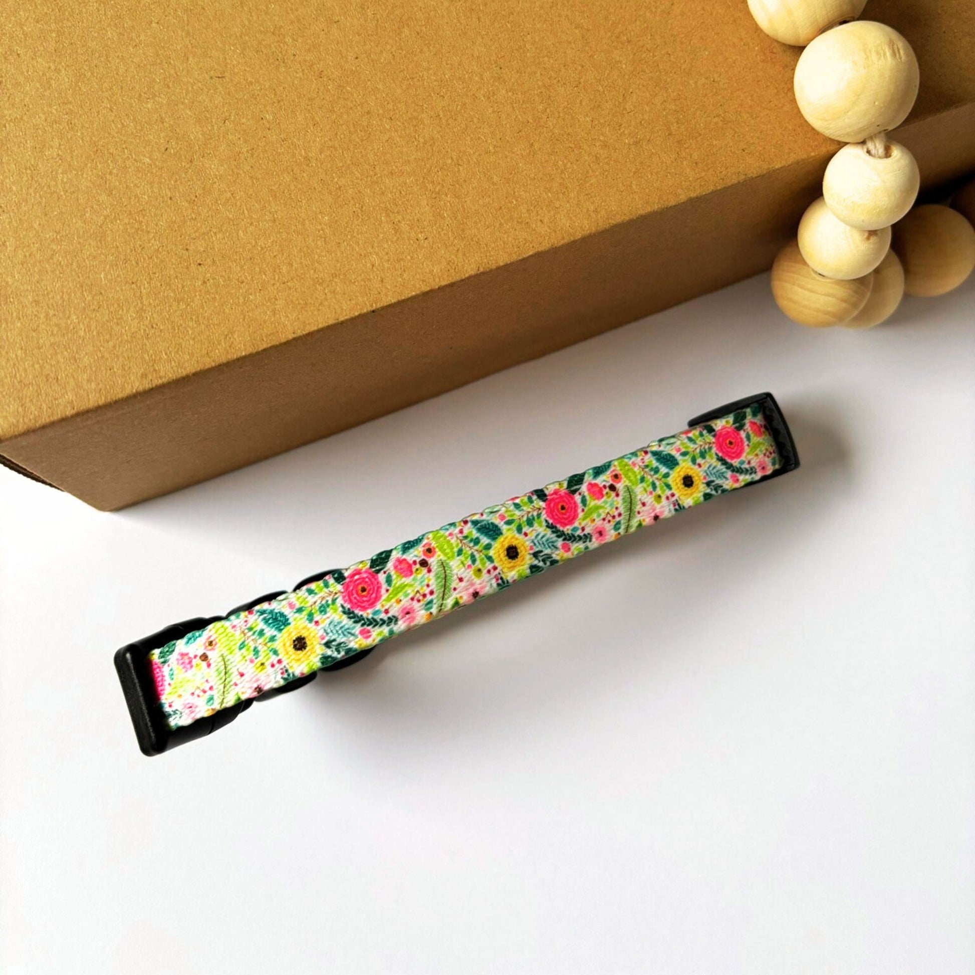 Top view of the back side of our Bloom Floral Dog Collar showing the adjustable strap slider for a custom fit. Features secure 4-point locking buckle and strong D-ring, suitable for dogs from XS to L.