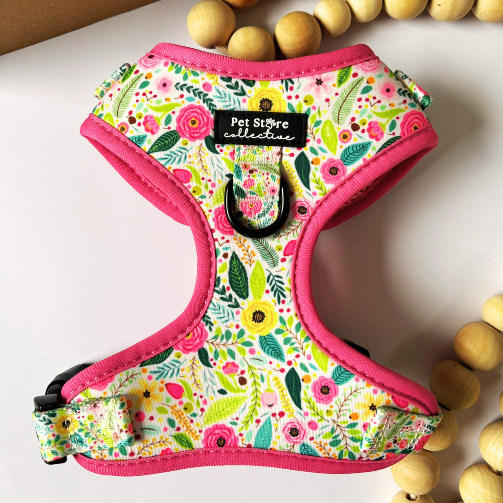 Close-up of our Bloom Floral Adjustable Dog Harness featuring custom pink roses and greenery print. Featuring our padded rim, adjustable straps, black safety buckle, and dual D-rings for secure and comfortable walking.