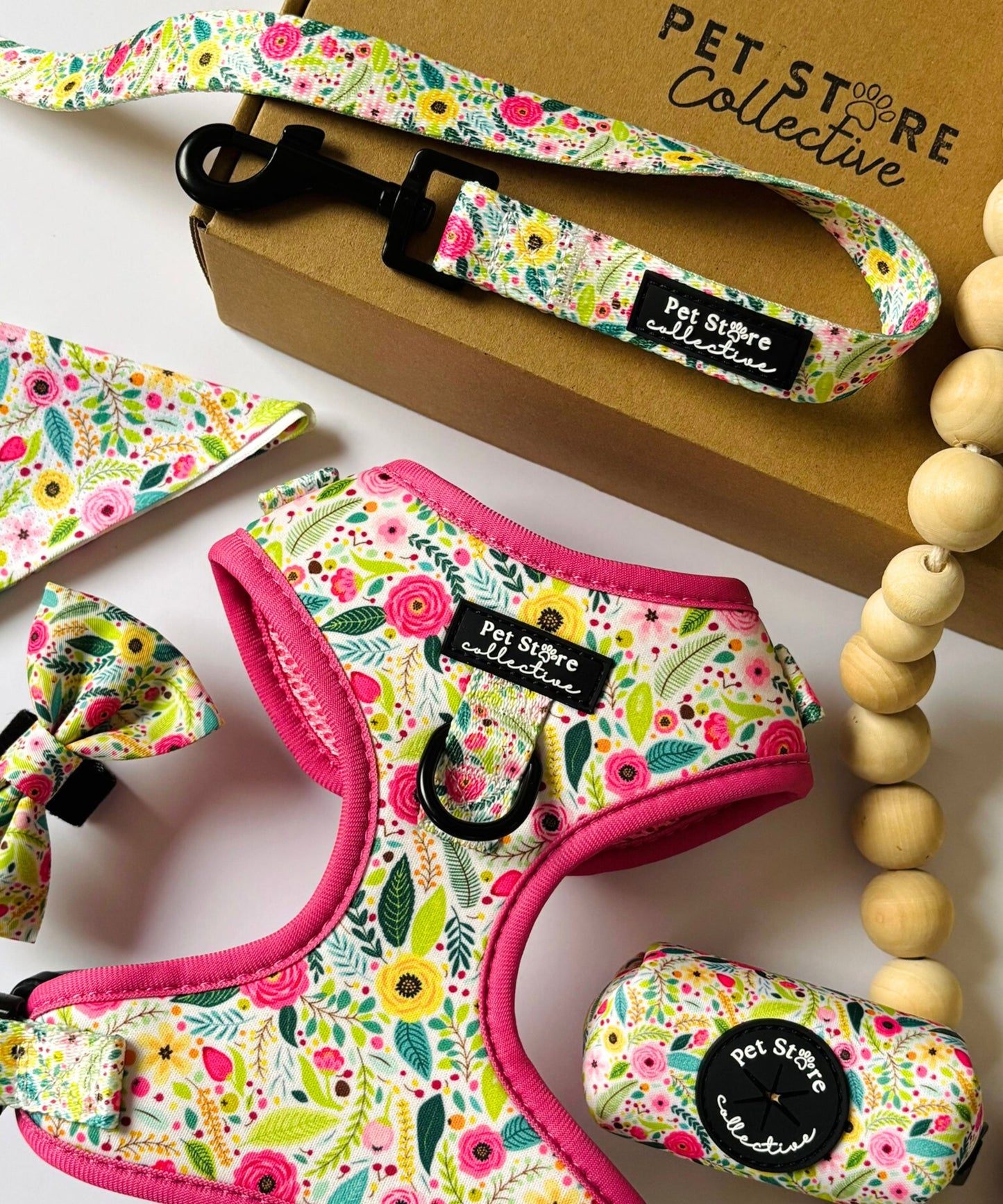 Complete Bloom Floral dog walking set featuring matching harness, collar, lead, bowtie, bandana, and poop bag holder. Designed for stylish and safe, coordinated walks with your pet.