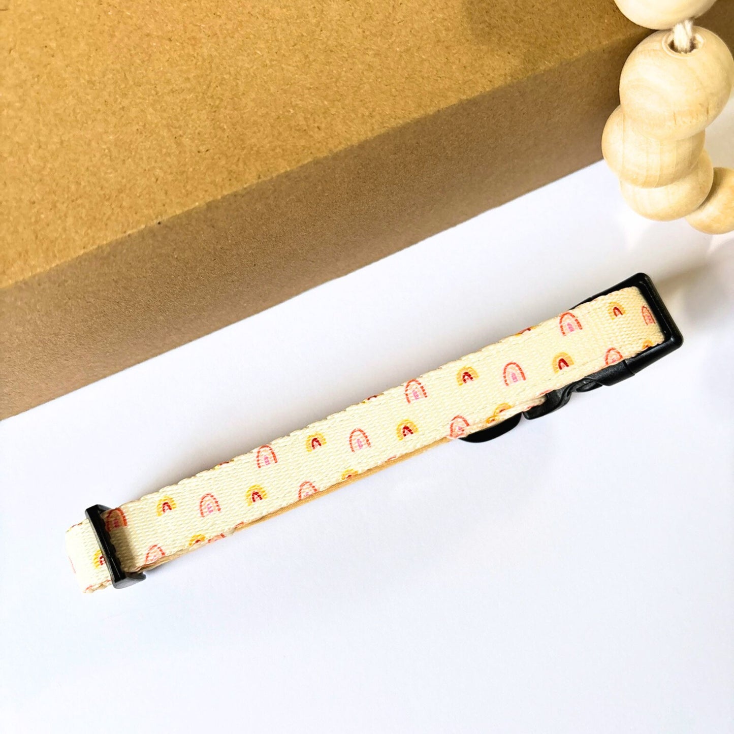 Close-up of the back of Pet Store Collective Boho Rainbow Dog Collar. Lightweight and stylish with safety buckle and D-ring, part of matching harness, lead, bandana, bow tie, and poop bag holder collection.