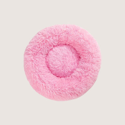 Lush Pink Calming Donut Pet Bed: Experience ultimate pet comfort with our best-selling dog bed. Embrace security with its circular design for a sense of cosiness and warmth. Raised edges provide neck and body support. Crafted from plush materials for extra softness and easy machine washable maintenance.