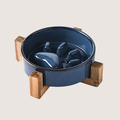 Blue Colour: Ceramic slow feeder dog bowl with charming paw print pattern and elevated wooden base, promoting comfortable and hygienic feeding. Durable, anti-slip, and resistant to chipping for lasting use. Elevate mealtime with style and functionality. Dishwasher safe for easy cleaning.