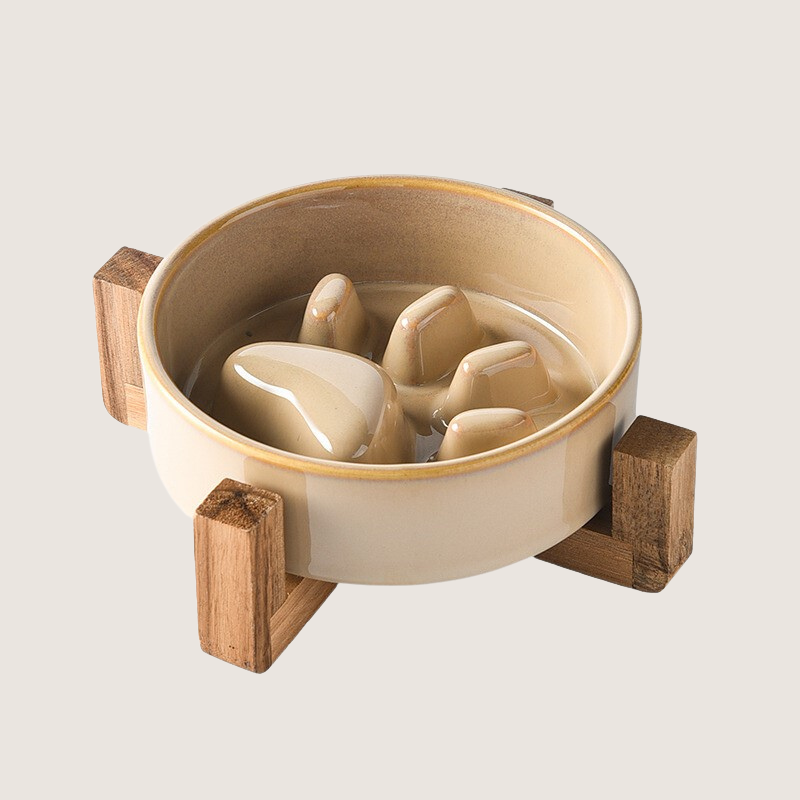 Brown Colour: Ceramic slow feeder dog bowl with charming paw print pattern and elevated wooden base, promoting comfortable and hygienic feeding. Durable, anti-slip, and resistant to chipping for lasting use. Elevate mealtime with style and functionality. Dishwasher safe for easy cleaning.