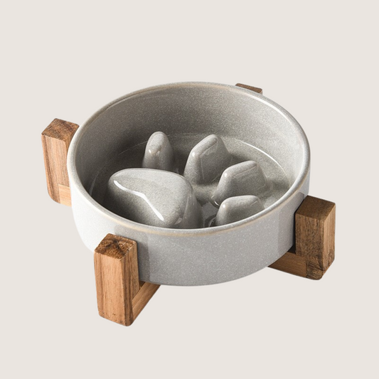 Grey Colour: Ceramic slow feeder dog bowl with charming paw print pattern and elevated wooden base, promoting comfortable and hygienic feeding. Durable, anti-slip, and resistant to chipping for lasting use. Elevate mealtime with style and functionality. Dishwasher safe for easy cleaning.