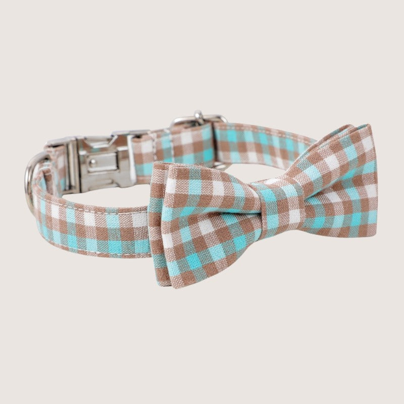 Aqua Colour: Stylish gingham bow tie dog collars crafted from premium cotton, available in four sizes: extra small, small, medium, and large. Adjustable ranges from 15cm to 60cm ensure a perfect fit for your furry friend. Features zinc alloy hardware, including a D-ring and quick-release buckle for convenience. Detachable bow tie offers versatile styling options. Choose from five timeless colours to match your pup's personality.