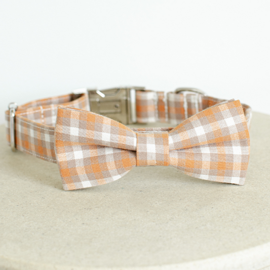 Orange Colour: Stylish gingham bow tie dog collars crafted from premium cotton, available in four sizes: extra small, small, medium, and large. Adjustable ranges from 15cm to 60cm ensure a perfect fit for your furry friend. Features zinc alloy hardware, including a D-ring and quick-release buckle for convenience. Detachable bow tie offers versatile styling options. Choose from five timeless colours to match your pup's personality.