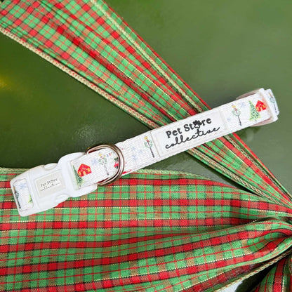 Our limited release Christmas Magic Adjustable Dog Collar. Featuring snowy Christmas trees, twinkling lights, and red cottages on a festive print, designed in Australia by Pet Store Collective.