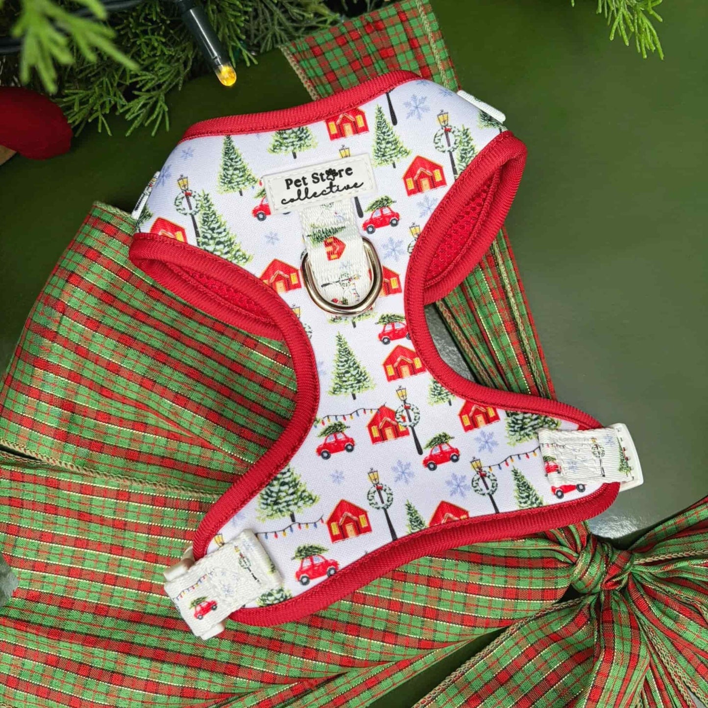 Our limited release Christmas Magic Adjustable Dog Harness. A festive red and white design featuring Christmas trees, cottages, and twinkling lights. Crafted from lightweight, quick-dry neoprene with breathable mesh for comfort and festive style.