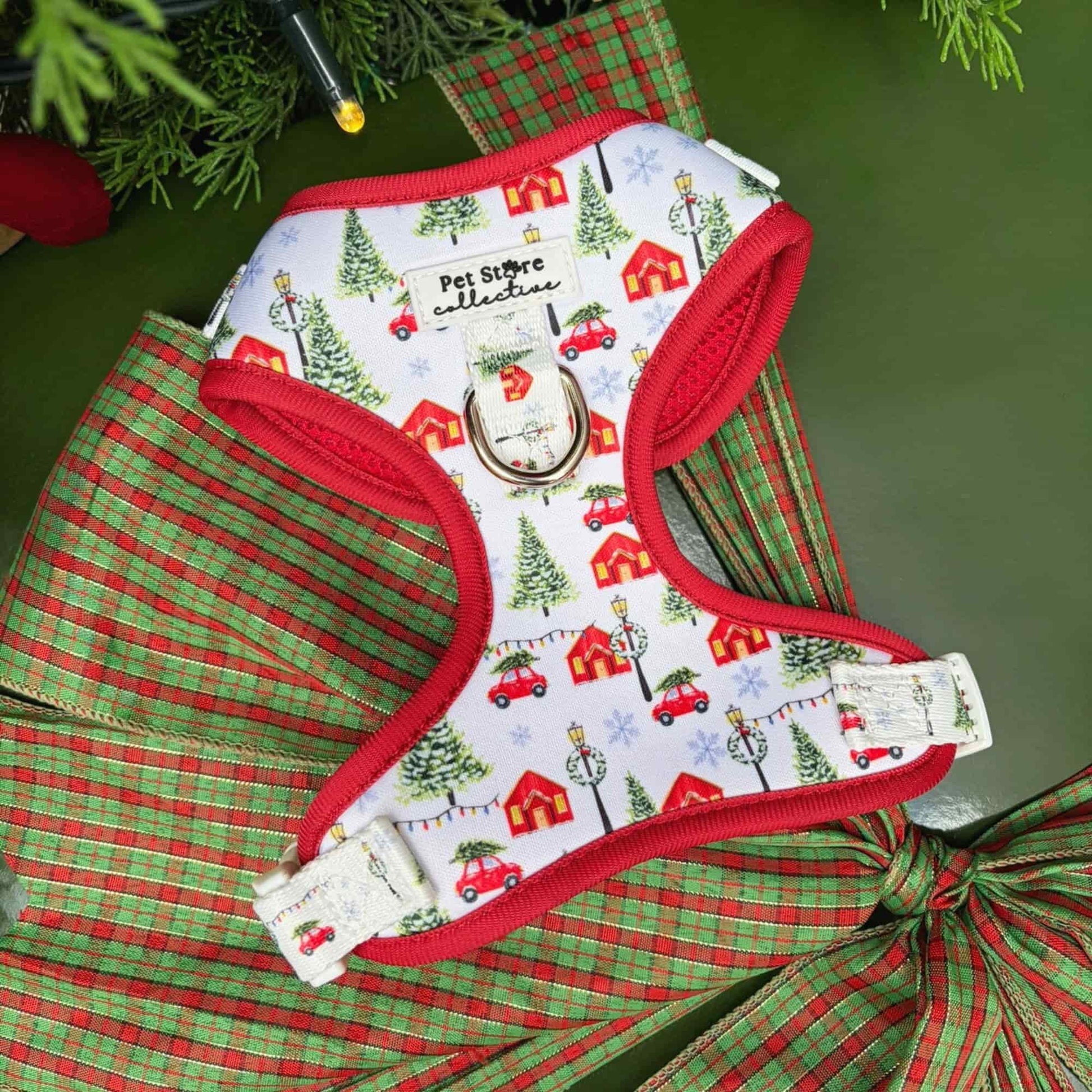 Our limited release Christmas Magic Adjustable Dog Harness. A festive red and white design featuring Christmas trees, cottages, and twinkling lights. Crafted from lightweight, quick-dry neoprene with breathable mesh for comfort and festive style.