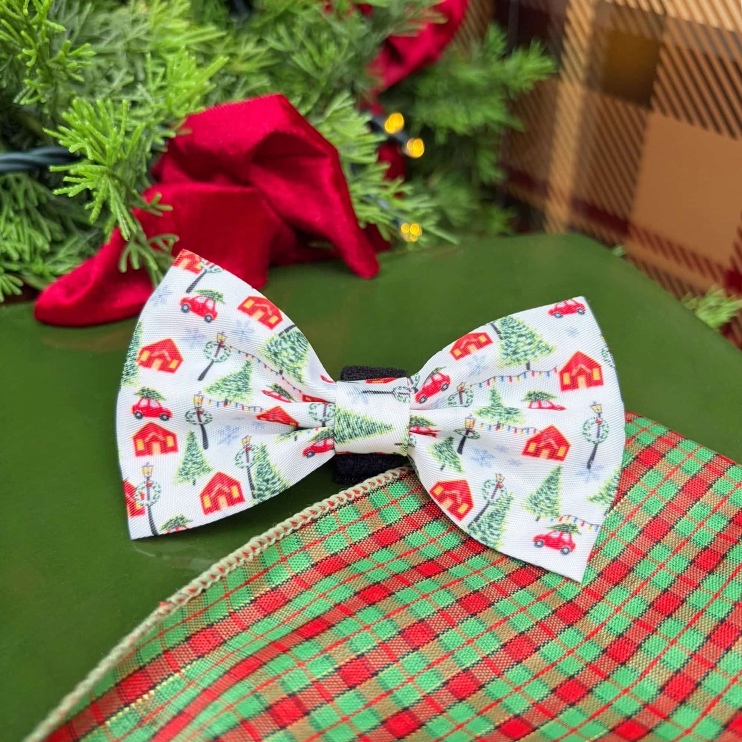 Our Christmas Magic Bow Tie in festive red and white features snowy Christmas trees, twinkling lights, and red cottages. Our limited release design made for celebrating the holidays with your furry family.