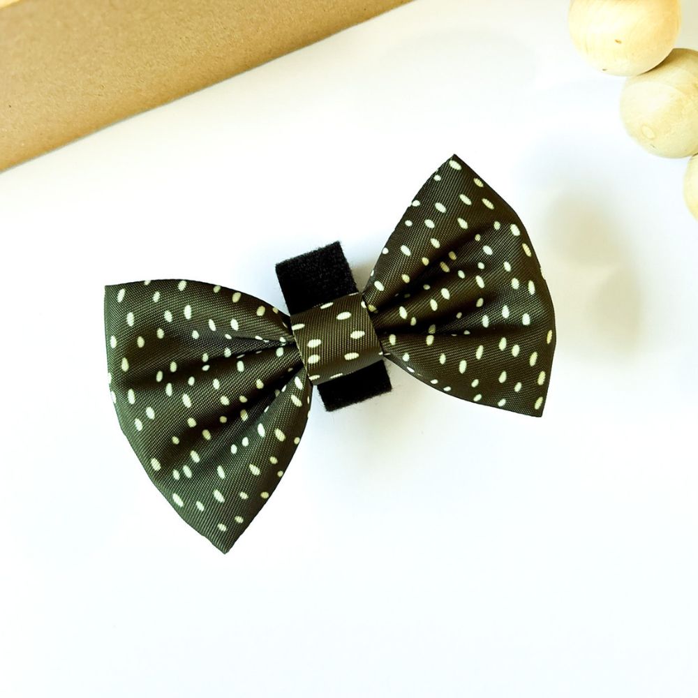 Dottie Days olive green dog bow tie flat lay with soft cream polka dots by Pet Store Collective.
