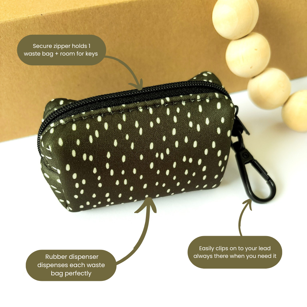 Dottie Days olive green poop bag holder showing secure zip closure and lead clip with callouts by Pet Store Collective.
