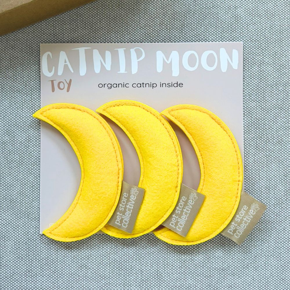 Pet Store Collective handmade yellow moon catnip toys pack of three with organic catnip, displayed on grey linen with PSC gift box in the left top hand corner.