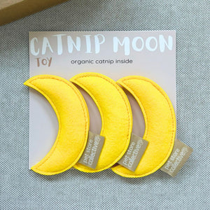 Pet Store Collective handmade yellow moon catnip toys pack of three with organic catnip, displayed on grey linen with PSC gift box in the left top hand corner.