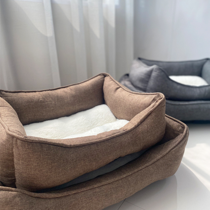Our brown and grey pet beds shown together, available in both small and large sizes. Each bed is designed with elevated edges and soft cotton lining for a snug and supportive rest, ideal for pets of all sizes.