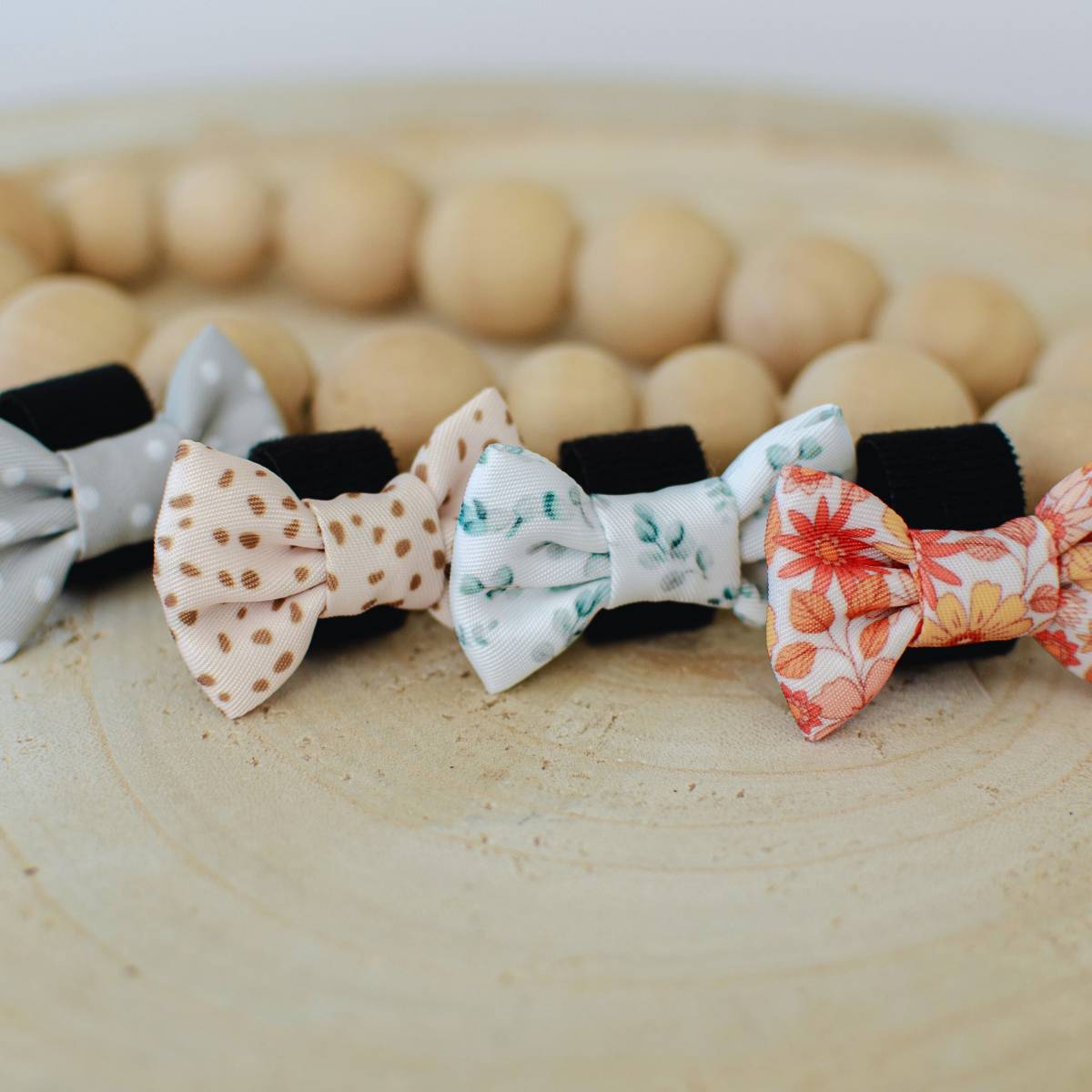 Our full collection of cat bow ties in sage green polka dots, amber speckled, gum leaves, and wildflower prints – exclusive to Pet Store Collective.