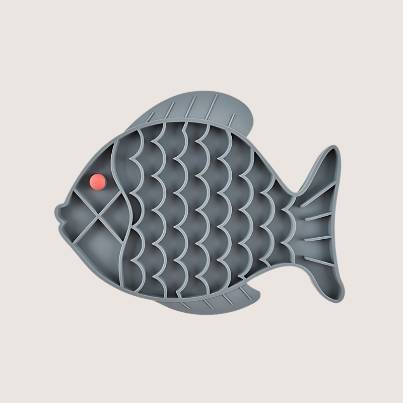 Grey fish-shaped silicone lick mat measuring 19CM x 24.5CM, made from food-grade, BPA-free silicone. Freezer and dishwasher safe, designed to slow down mealtime and reduce digestive issues.