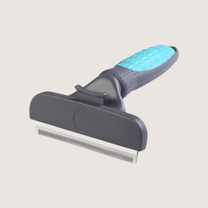 Grey deshedding brush with quick-release button for easy hair disposal, designed to efficiently remove loose undercoat while being gentle on your dog’s topcoat.