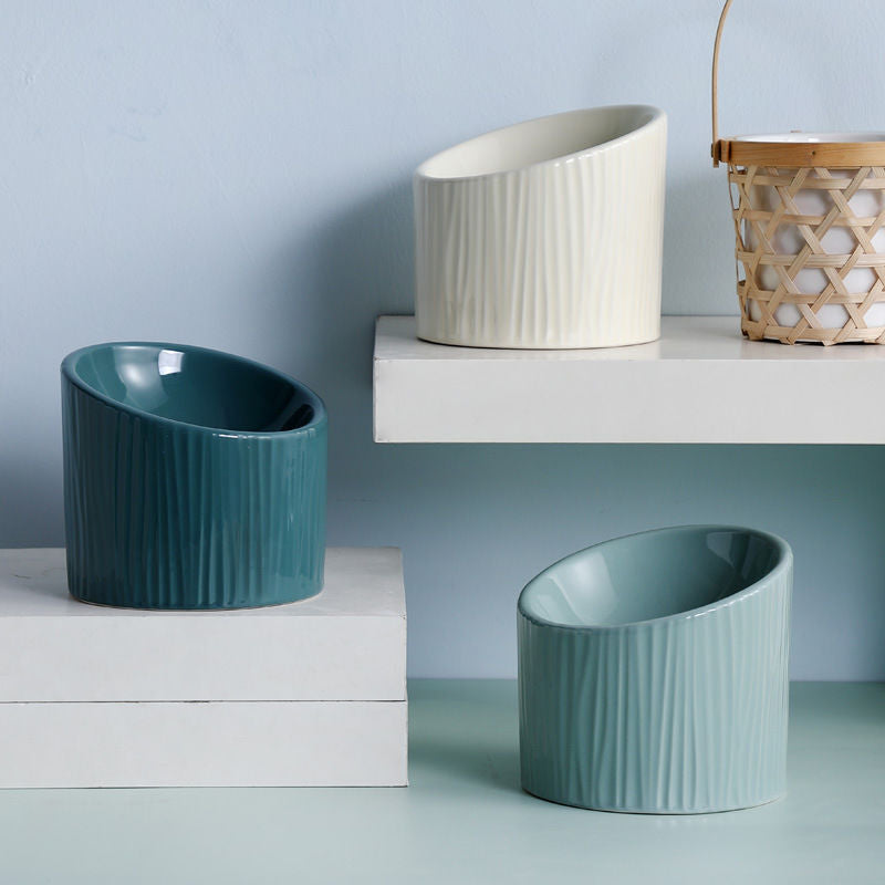 Elevated nature-inspired ceramic pet bowls in light green, dark green, and off-white. Dishwasher safe, designed for comfort. Sizes: 15.5CM width, 14.5CM back height, 10CM front height, 170ML capacity.