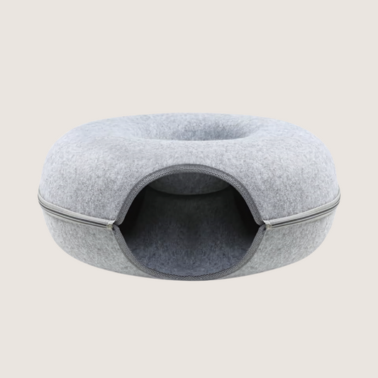 Light grey donut tunnel toy in size medium (52cm length x 20cm height). Spoil your cat with this toy designed to engage their hunting instincts. Rounded corners promise hours of fun and excitement. Easy to set up, super durable, and made from breathable flannel, it's perfect for keeping your feline friend happy and active. Whether for play, rest, or a cosy catnap spot, this versatile design is their new favourite. Shop now with confidence, backed by our 30-day money-back guarantee. 