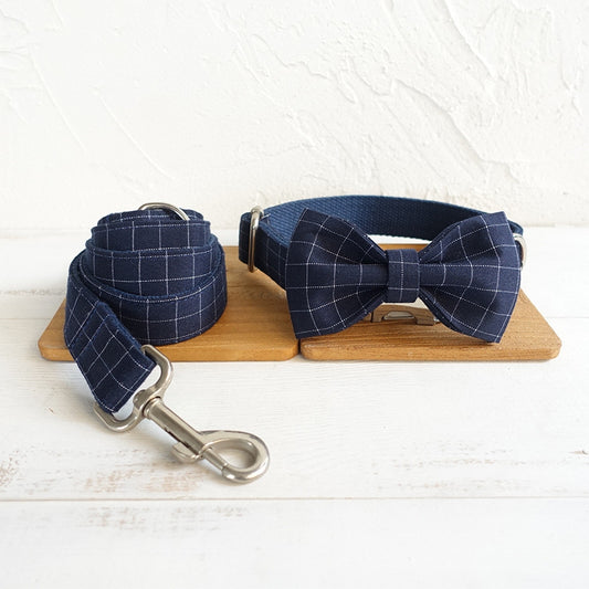 Navy Gingham Dog Collar Set: Stylish, Comfortable, and Functional. Embrace your pet's unique charm with our lightweight polyester collar, adjustable for a perfect fit. The lead features a 360° swivel anti-tangle design and durable metal alloy hardware, all in one convenient set.