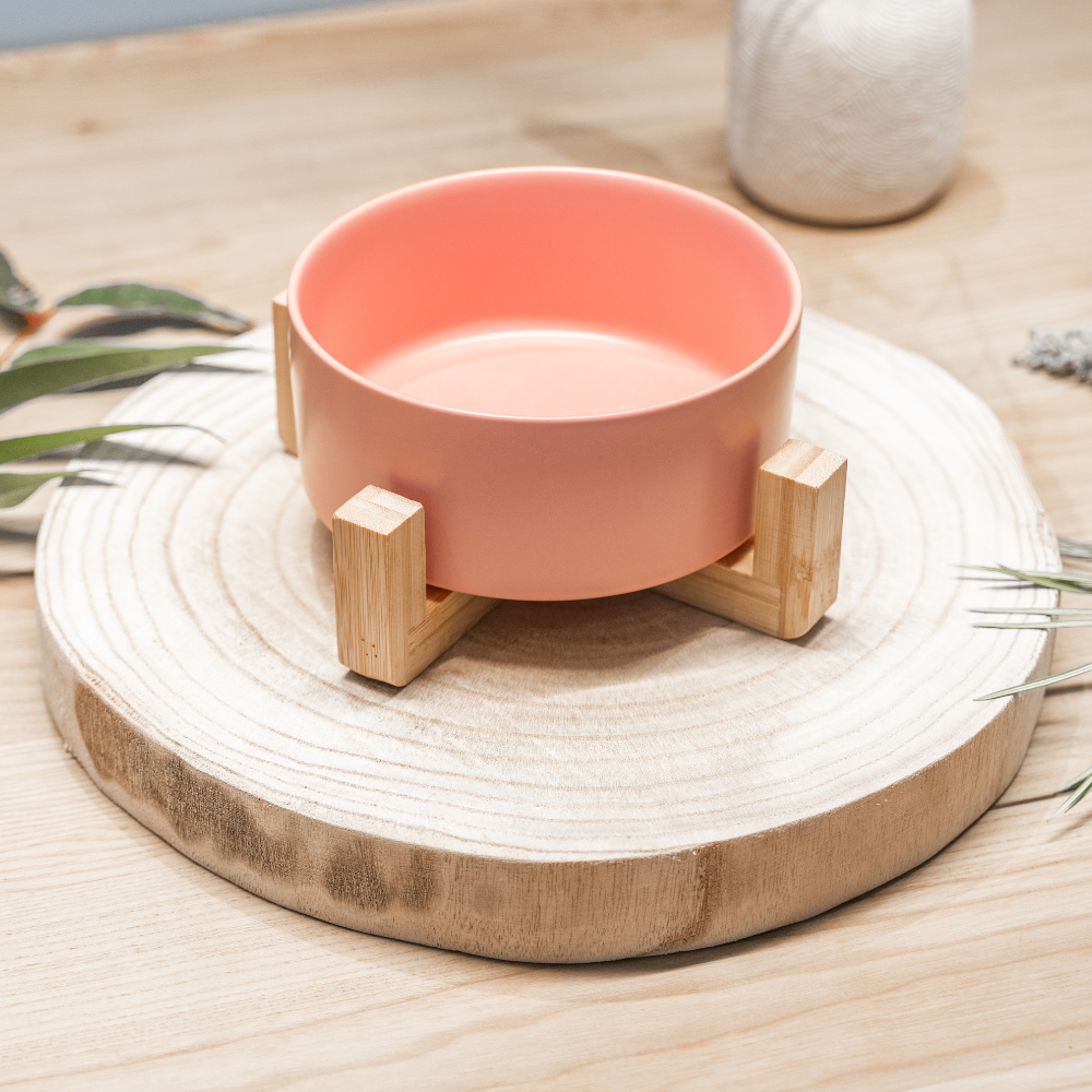 Petal Pink Ceramic Pet Bowl with an eco-friendly bamboo base, 19.5 cm long and 9 cm high, with a capacity of 3.6 cups (850 ml). Designed for durability and practicality, this bowl supports your pet’s natural feeding posture, features high edges to reduce spills, and is dishwasher-safe. It includes an embossed Pet Store Collective logo inside the bottom.