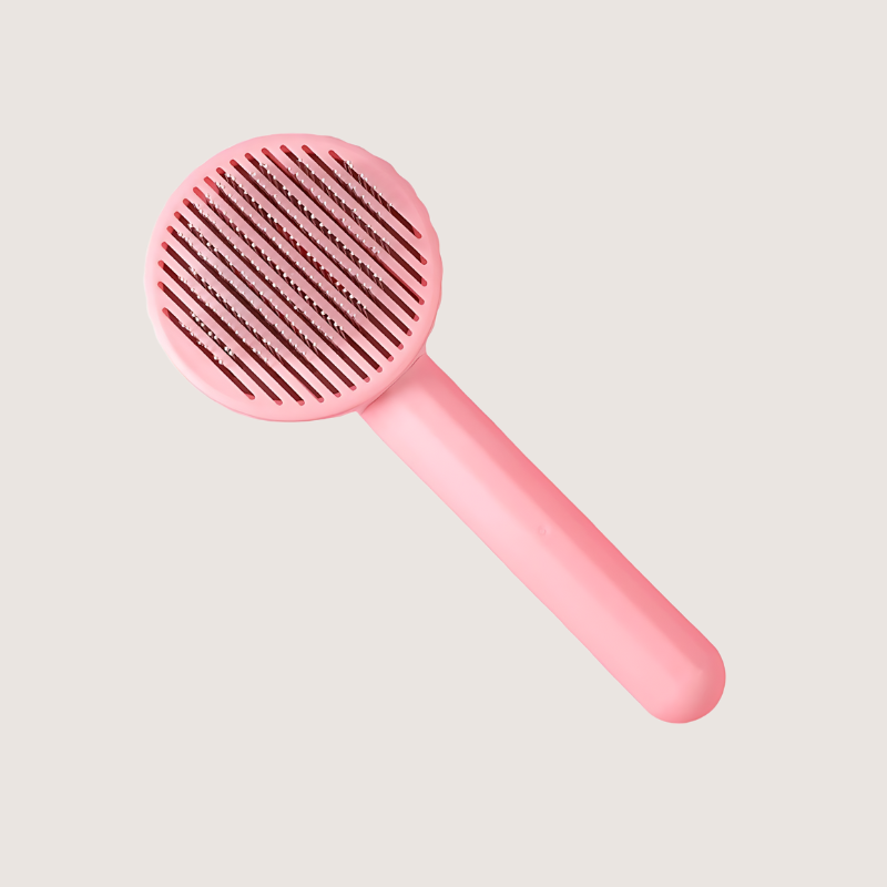 Stainless-steel slicker brush in pink for small to medium-sized pets. Features an anti-slip handle and flexible 60-degree bristles for smooth grooming and easy hair release.