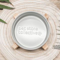 Our Silver Mist Ceramic Pet Bowl with a bamboo base, 19.5 cm in length and 9 cm in height, filled with food or water. With a 3.6 cup (850 ml) capacity, the bowl features high edges to minimise spills and is dishwasher-safe for easy cleanup. The elegant silver mist finish and embossed Pet Store Collective logo inside the bottom make it a chic and functional choice for any pet.