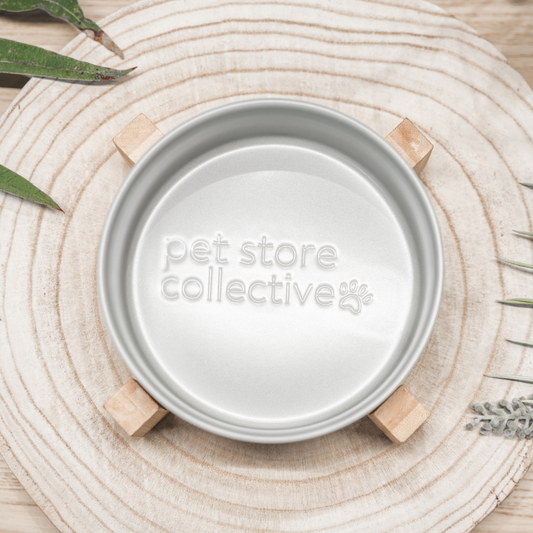 Our Silver Mist Ceramic Pet Bowl with a bamboo base, 19.5 cm in length and 9 cm in height, filled with food or water. With a 3.6 cup (850 ml) capacity, the bowl features high edges to minimise spills and is dishwasher-safe for easy cleanup. The elegant silver mist finish and embossed Pet Store Collective logo inside the bottom make it a chic and functional choice for any pet.