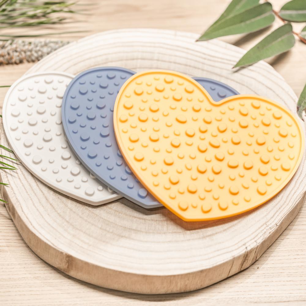 Explore the Sunset Citrus, Sky Breeze, and Moon Mist Heart Licking Mat collection, each measuring 20 cm by 17.4 cm. Made from 100% food-grade silicone, BPA-free, these mats feature a textured surface for better digestion and mental engagement. With strong suction cups for stability and a subtle embossed Pet Store Collective logo on the back, they are dishwasher and freezer safe. Brighten up your pet’s mealtime with Pet Store Collective.