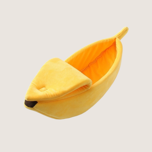 Yellow semi-closed banana cat bed with soft plush material, raised edge for neck support, foldable peel top with velcro for semi-open design. Ideal for play, rest, and sleep for small to medium-sized dogs and cats. Available sizes: Small (40x15x12cm), Medium (55x20x15cm), Large (65x25x18cm), X-Large (90x30x20cm).