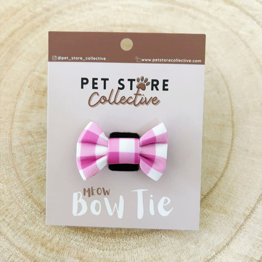 Our pink gingham cat bow tie attached to our custom Pet Store Collective packaging, showing our vibrant pink check design. Perfect mini size for kittens and cats  4.5 cm × 3 cm size, and with velcro backing that easily wraps around any cat collar.