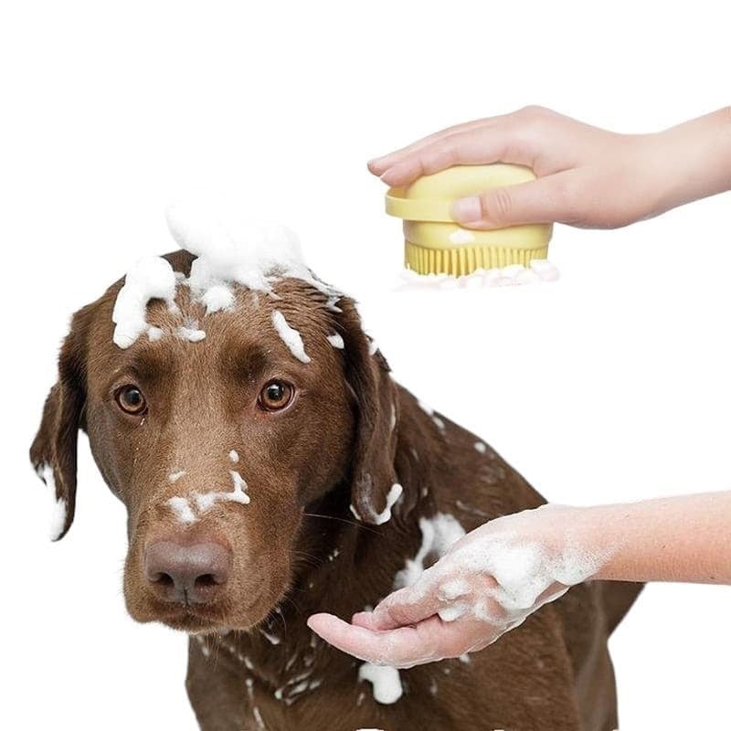 A dog getting an overall body wash with our yellow happy pet silicone bath scrub brush.