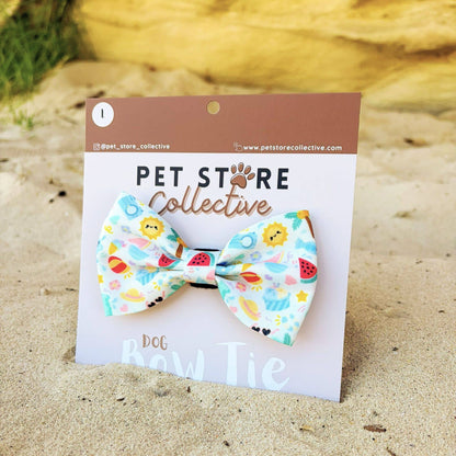 Angled view of our Summer Bliss dog bow tie. Crafted from soft polyester fabric with a secure Velcro backing that attaches to any pet collar. Designed for everyday comfort and bright summer style. Limited release by Pet Store Collective, available in two sizes.