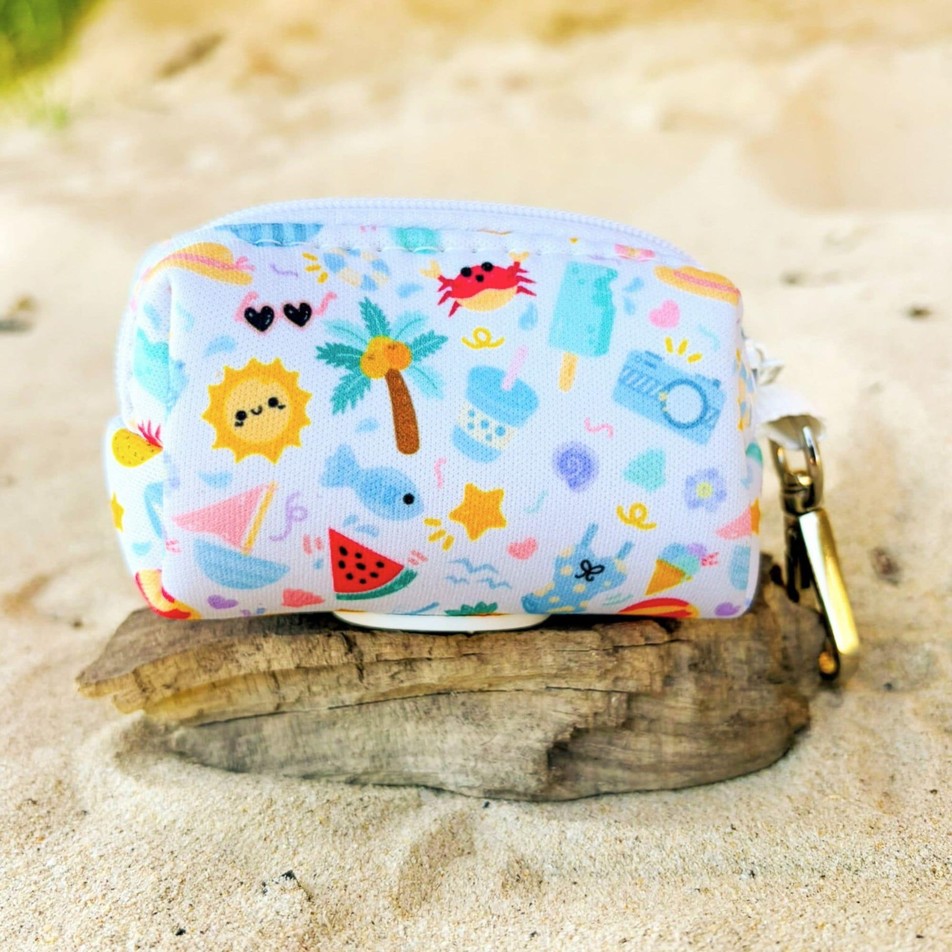Back view of our Summer Bliss dog poop bag holder showing the zipper closure and sturdy clip that easily attaches to a D-ring on your lead or  handbag. Lightweight neoprene design with a baby blue base and beach-inspired pattern, designed in Australia by Pet Store Collective.