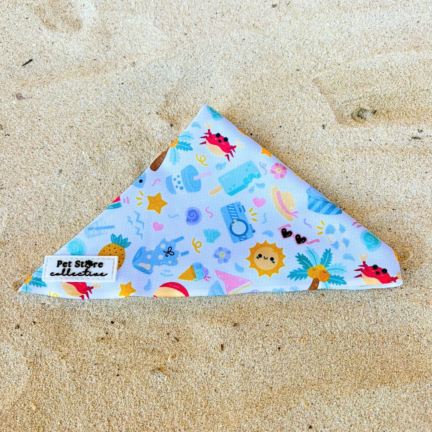 Front view of our limited release Summer Bliss Tie-Up Dog Bandana, featuring a bright, beach-inspired print. Crafted from lightweight, breathable fabric with an easy tie-up design for a comfy, adjustable fit, perfect for pups who love café hangs, beach walks, and sunny adventures.