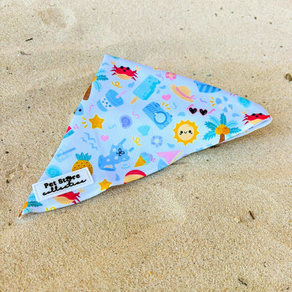 Angled view of our limited release Summer Bliss Tie-Up Dog Bandana showing our adorable beachside design and tie-up style. Crafted from breathable, lightweight fabric to keep pups cool and comfy, part of our matching Summer Bliss collection with harness, collar, lead, poop bag holder, and bow tie.