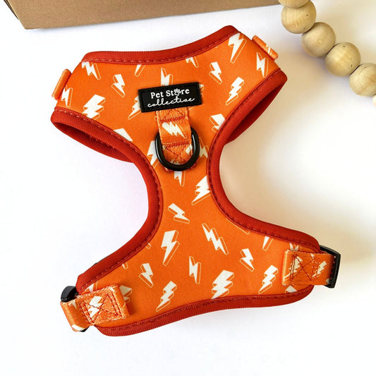 Front view of our Thunderbolt Adjustable Dog Harness in bright orange with white thunderbolts, crafted from quick-dry neoprene and breathable mesh with dual D-rings for no-pull training and everyday walks.