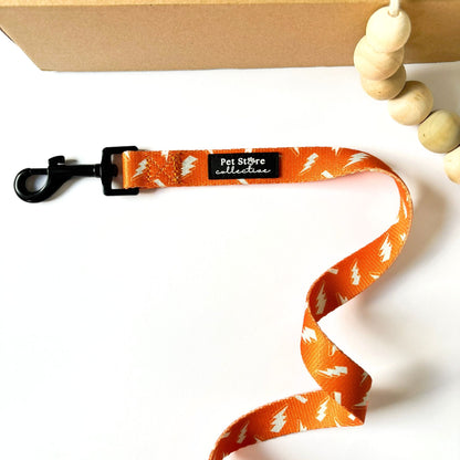 Our Thunderbolt Dog Lead in vibrant orange with white thunderbolt print. Featuring polyester wedding leash with neoprene-lined handle, durable dog accessory designed in Australia by Pet Store Collective.