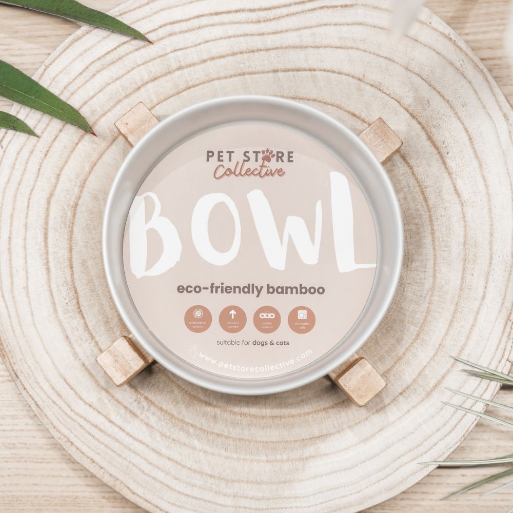 White ceramic pet bowl showing Pet Store Collective's custom packaging and eco-friendly bamboo base. Dishwasher safe ceramic bowl for easy cleaning.