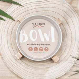 White ceramic pet bowl showing Pet Store Collective's custom packaging and eco-friendly bamboo base. Dishwasher safe ceramic bowl for easy cleaning.